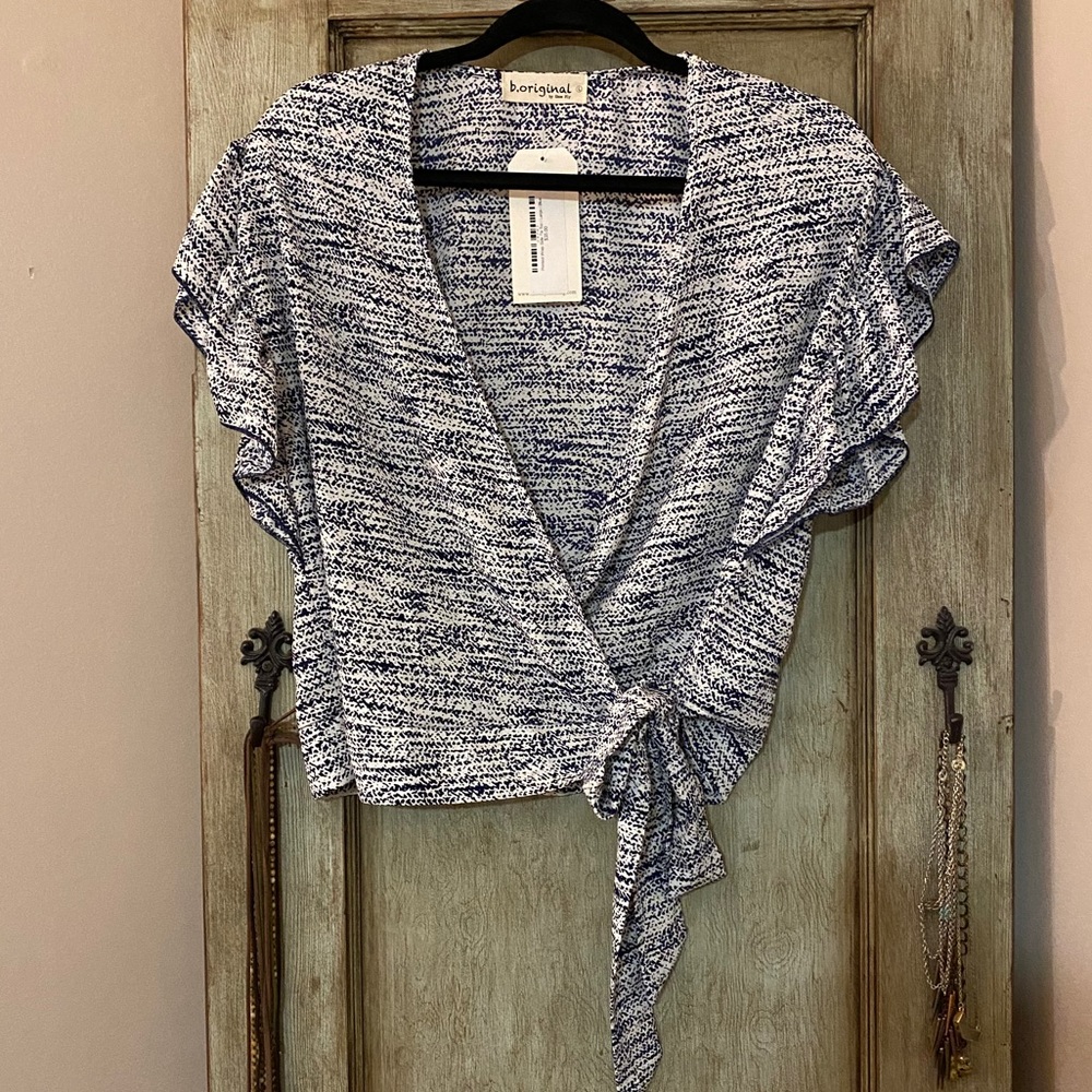 Boutique navy and white ruffle sleeve wrap top.